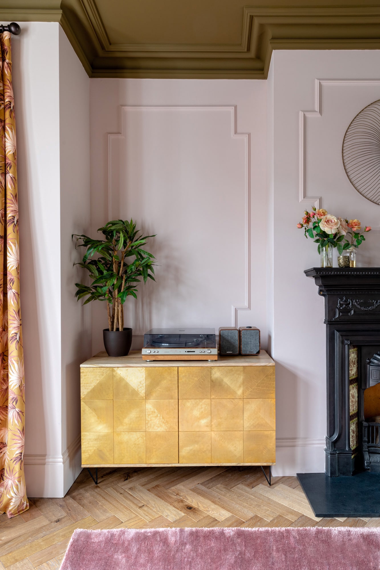 Interior detail shot: golden cabinet and a fireplace