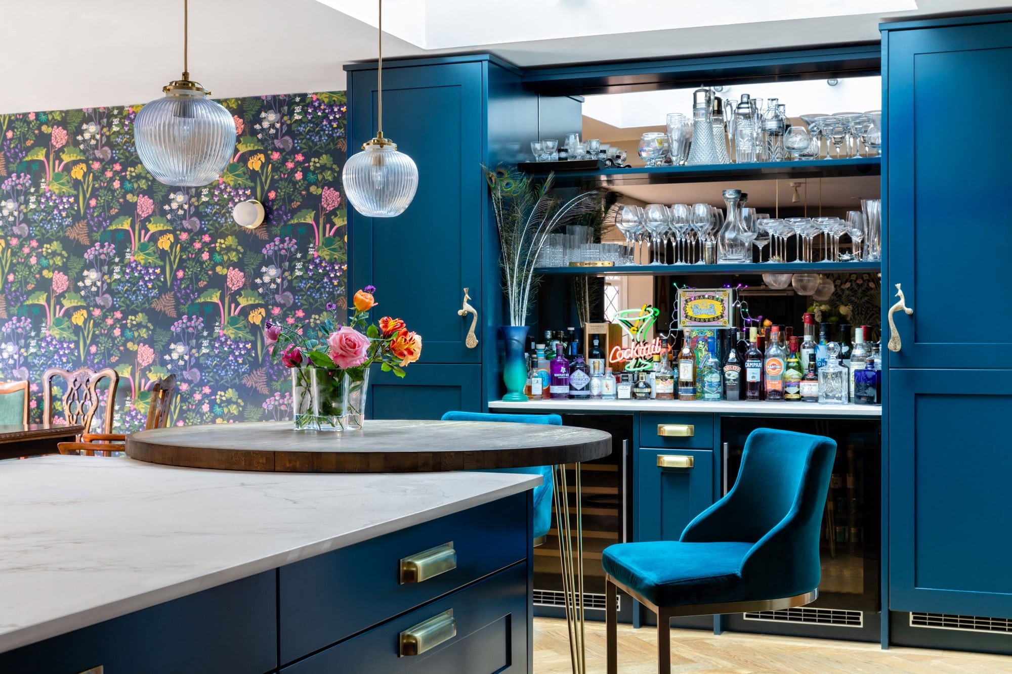 Vivid blue kitchen with open bar and hanging lights