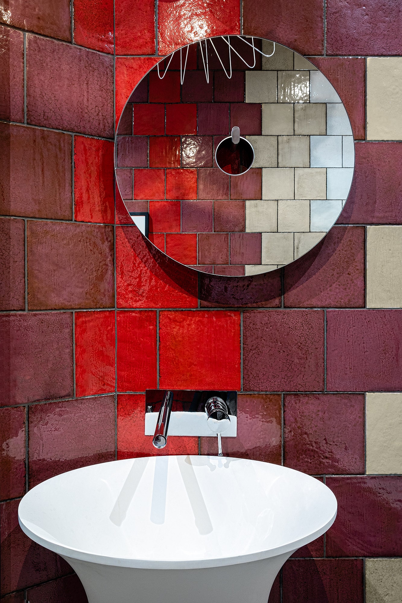 red and yellow tiles with round mirror